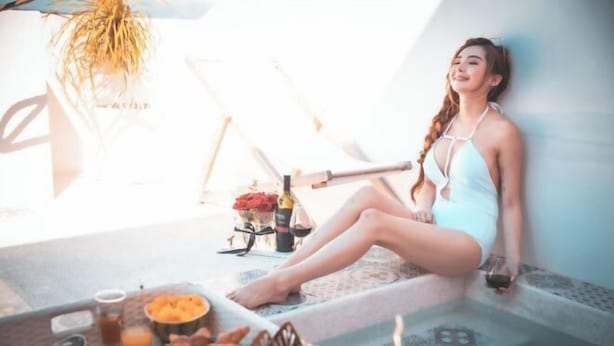 A person sitting on steps with a table of food and drinks in front of them. - Pinky Promise Villa (Pingtung)