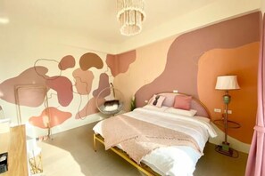 A bedroom with a bed, a hanging chair, a floor lamp, and abstract wall art. - Pinky Promise Villa (Pingtung)