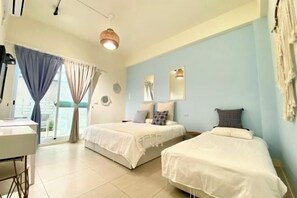 A room with two beds, a desk, and a large window with curtains. - Pinky Promise Villa (Pingtung)
