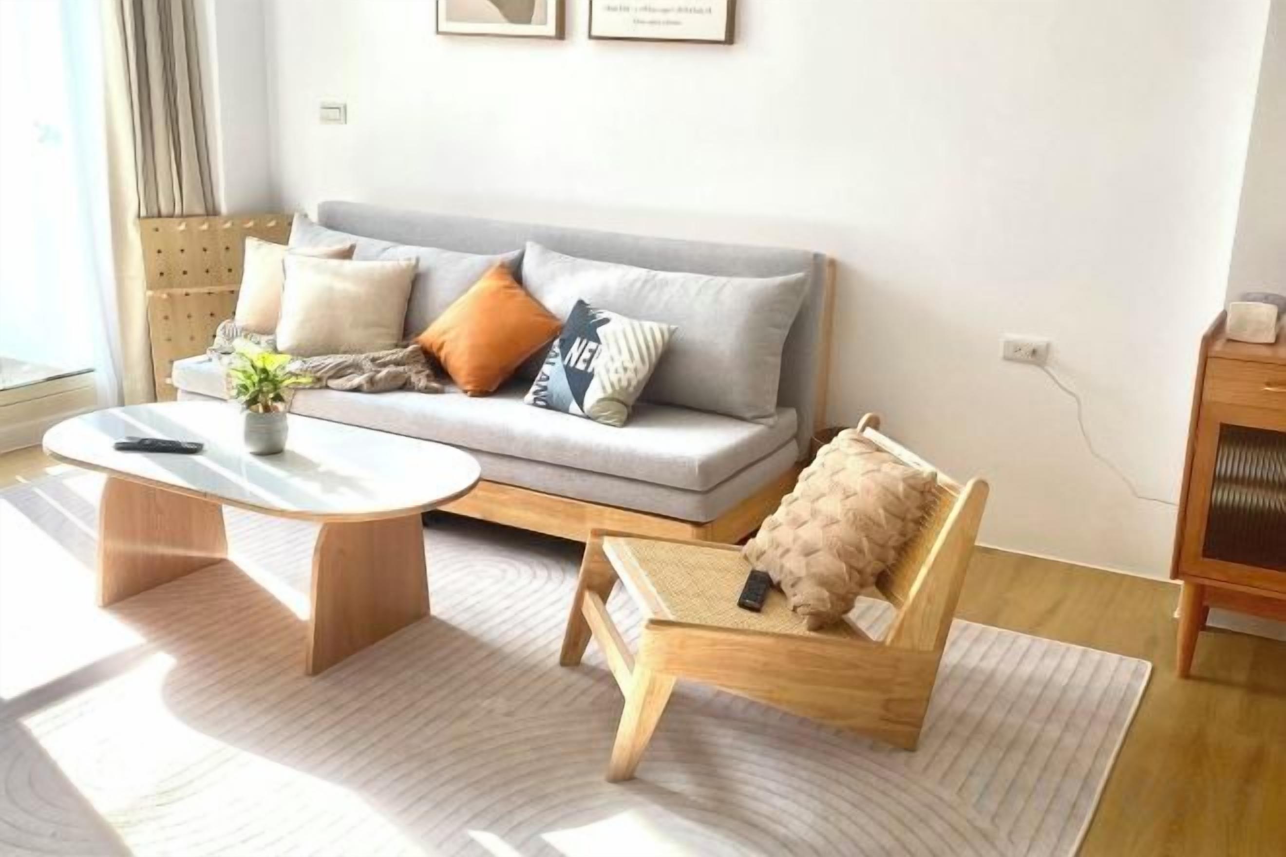 A modern living room with a sofa, coffee table, and a small wooden chair.