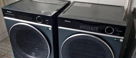 Deux machines à laver à chargement frontal dans une buanderie.