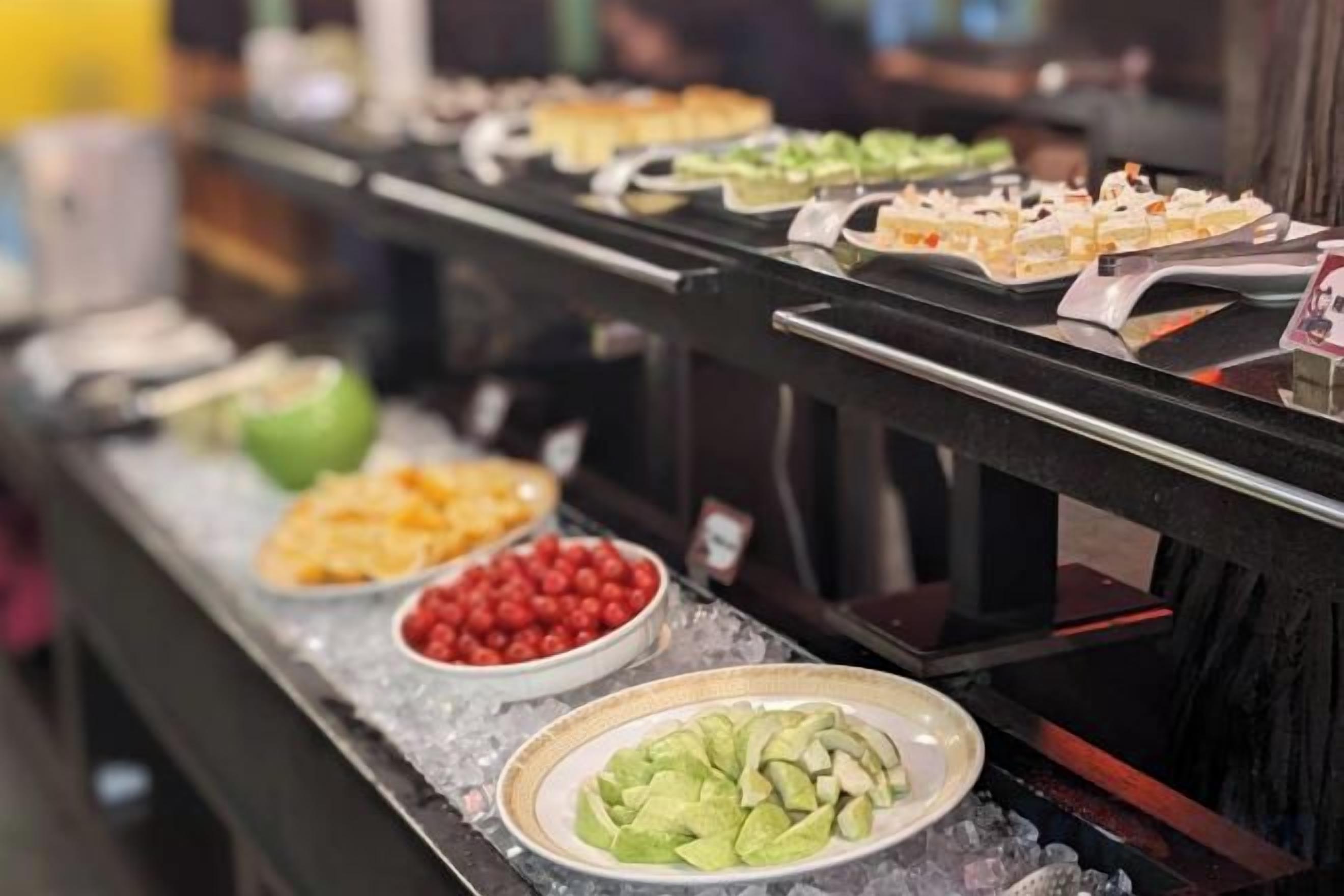 A buffet with various food items displayed on a counter.