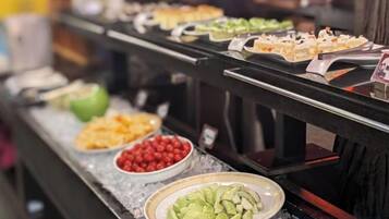 A buffet with various food items displayed on a counter.