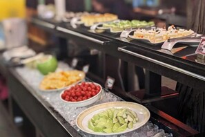A buffet with various food items displayed on a counter. - The M Village (Nantou)