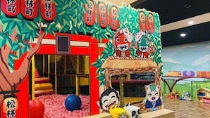 A children's play area with a ball pit, a slide, and cartoon character decorations. - The M Village (Nantou)
