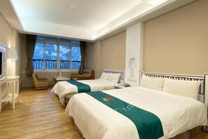 A hotel room with two beds, a desk, a chair, a TV, and a window with a view. - The M Village (Nantou)