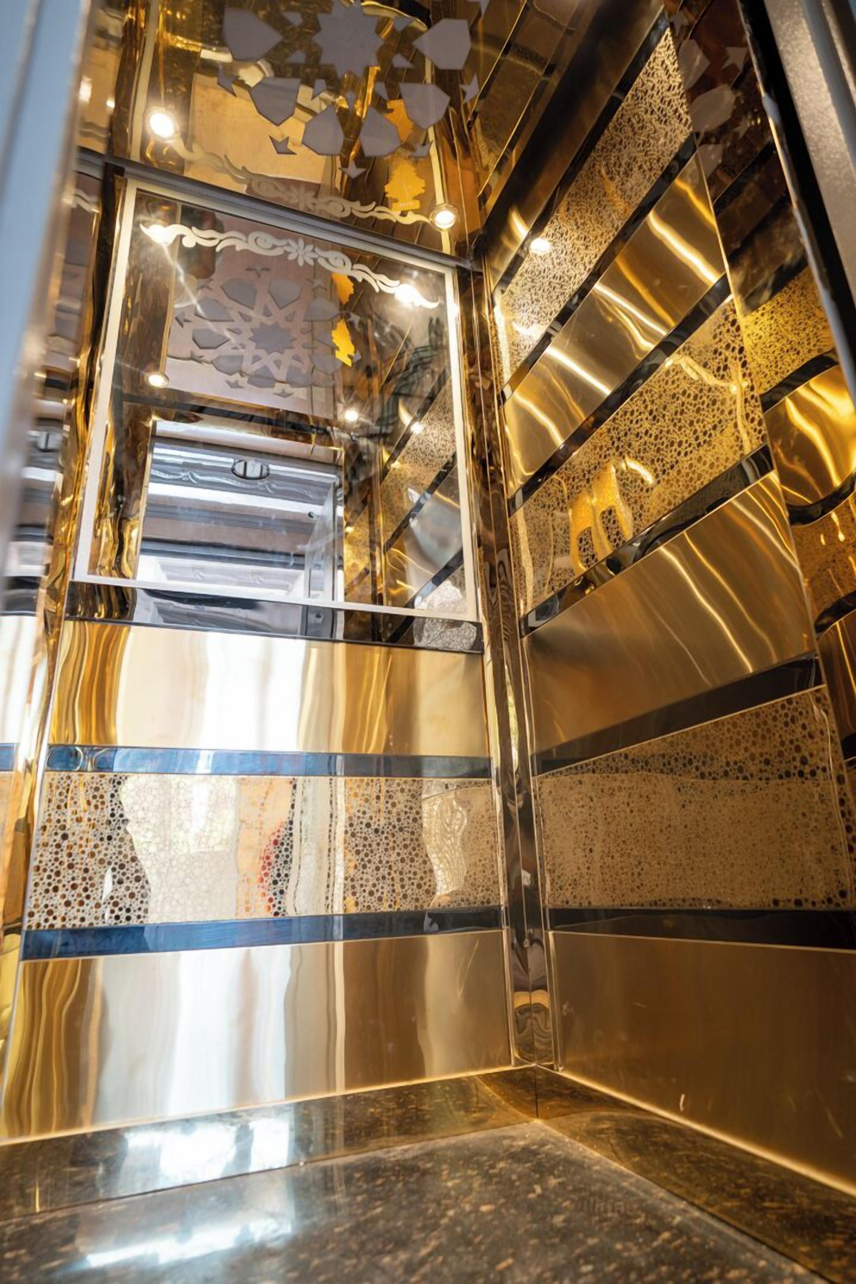 A metallic, reflective interior with geometric patterns and a central rectangular window.