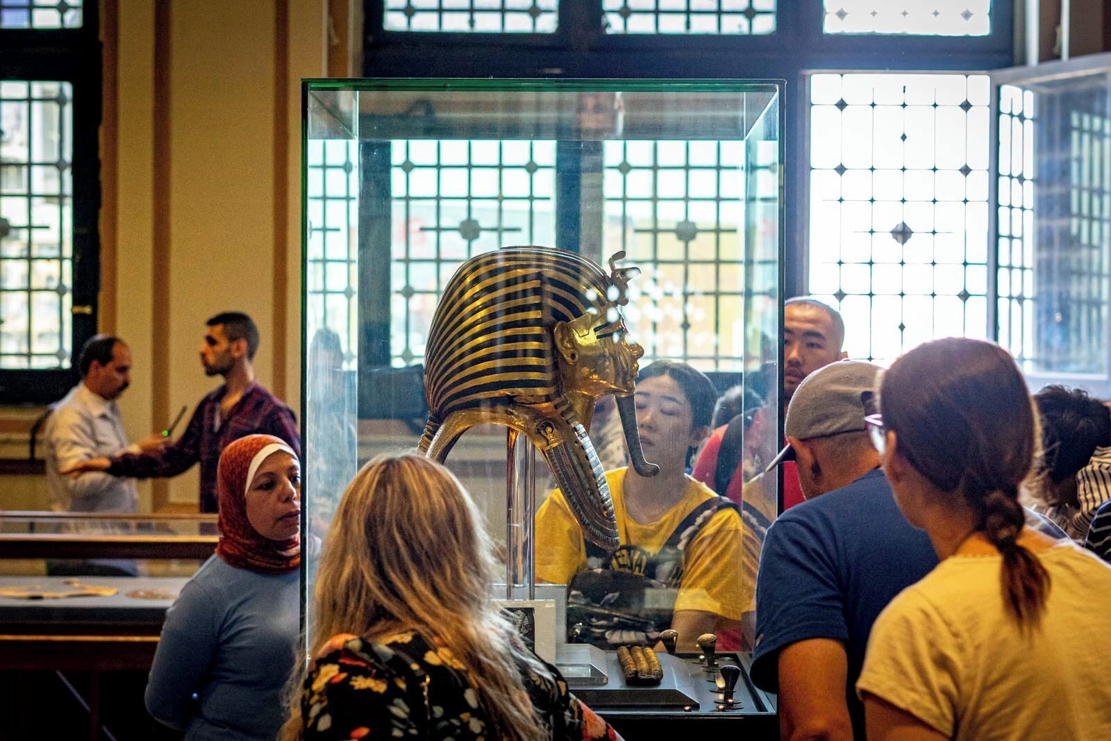 A museum exhibit with a large golden sarcophagus.