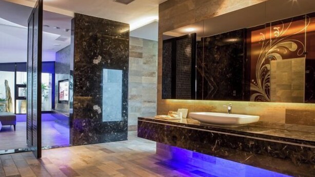 A modern bathroom with a marble sink, a large mirror, and a blue-lit vanity. - ALL-UR Boutique Motel Hua-Lian Branch (Hualien)