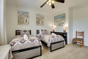 A bedroom with two beds, a ceiling fan, and artwork on the walls. - Mtn-View Patio Oasis! Luxe Family Home in Peoria (Peoria)