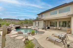A residential property with a swimming pool, patio furniture, and a cactus. - Mtn-View Patio Oasis! Luxe Family Home in Peoria (Peoria)
