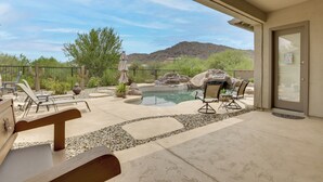 A pool area with lounge chairs, a hot tub, and a view of a mountain. - Mtn-View Patio Oasis! Luxe Family Home in Peoria (Peoria)