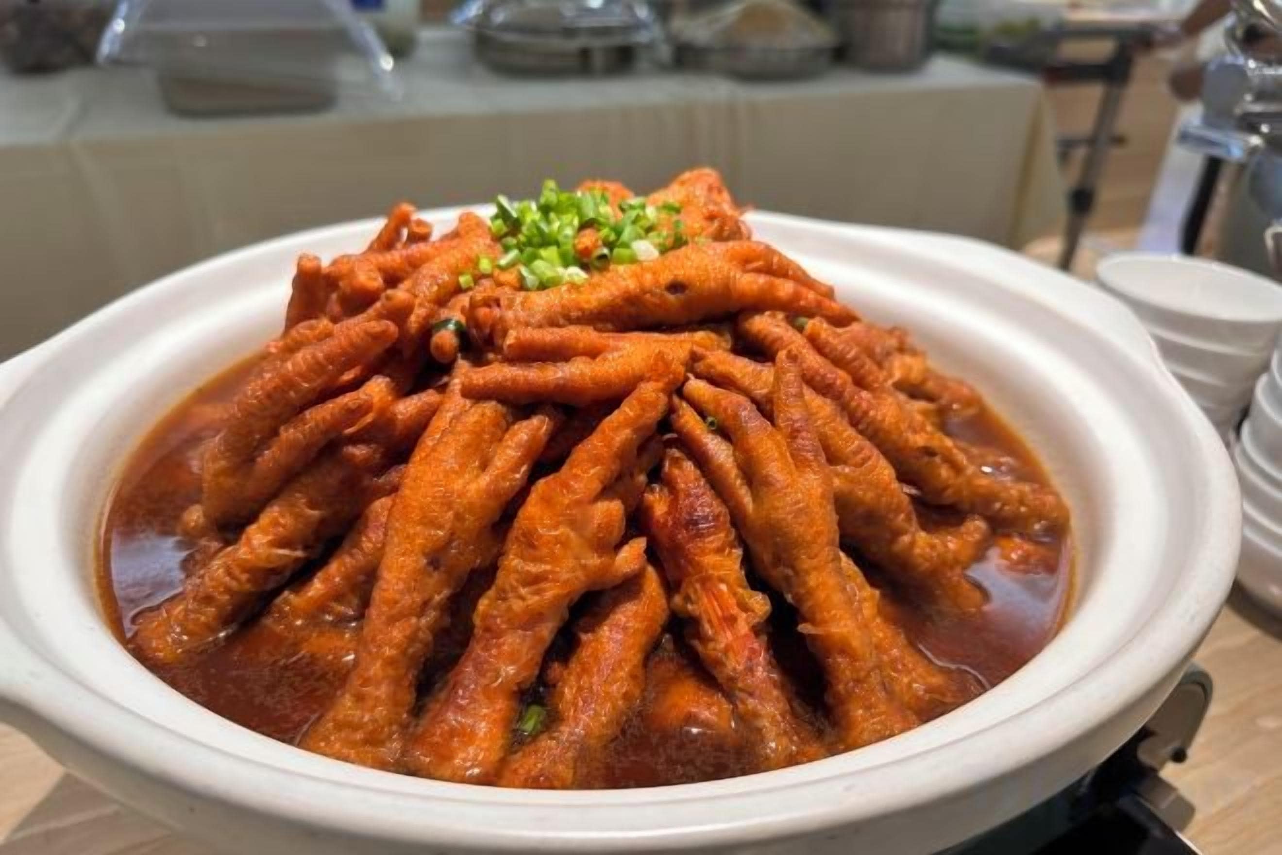 A bowl of spicy food with a garnish on top.