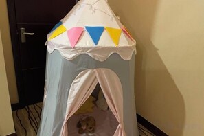 A small, enclosed play area with a tent-like structure and a soft bed inside. - Shandong Energy International Hotel (Tai'an)
