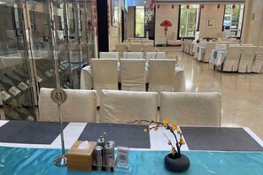 A hotel conference room with tables set for a meeting, numbered 43, and a vase with flowers on the table. - Shandong Energy International Hotel (Tai'an)