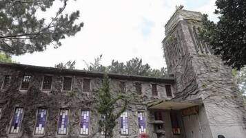 A building with a stone facade and multiple windows.