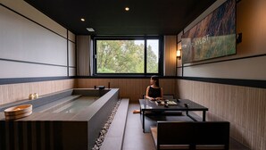 A modern spa room with a large bathtub, a table with tea set, and a painting on the wall. - Mitasuya Ryokan Hotel by Anook Gongju  (Gongju)