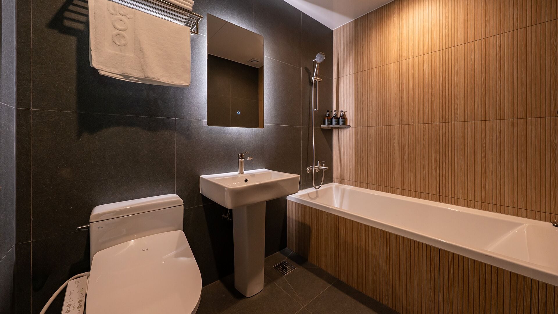 Un baño moderno con inodoro, lavamanos y bañera.