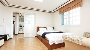 Une chambre à coucher avec un lit en bois, un canapé, un bureau et une armoire.