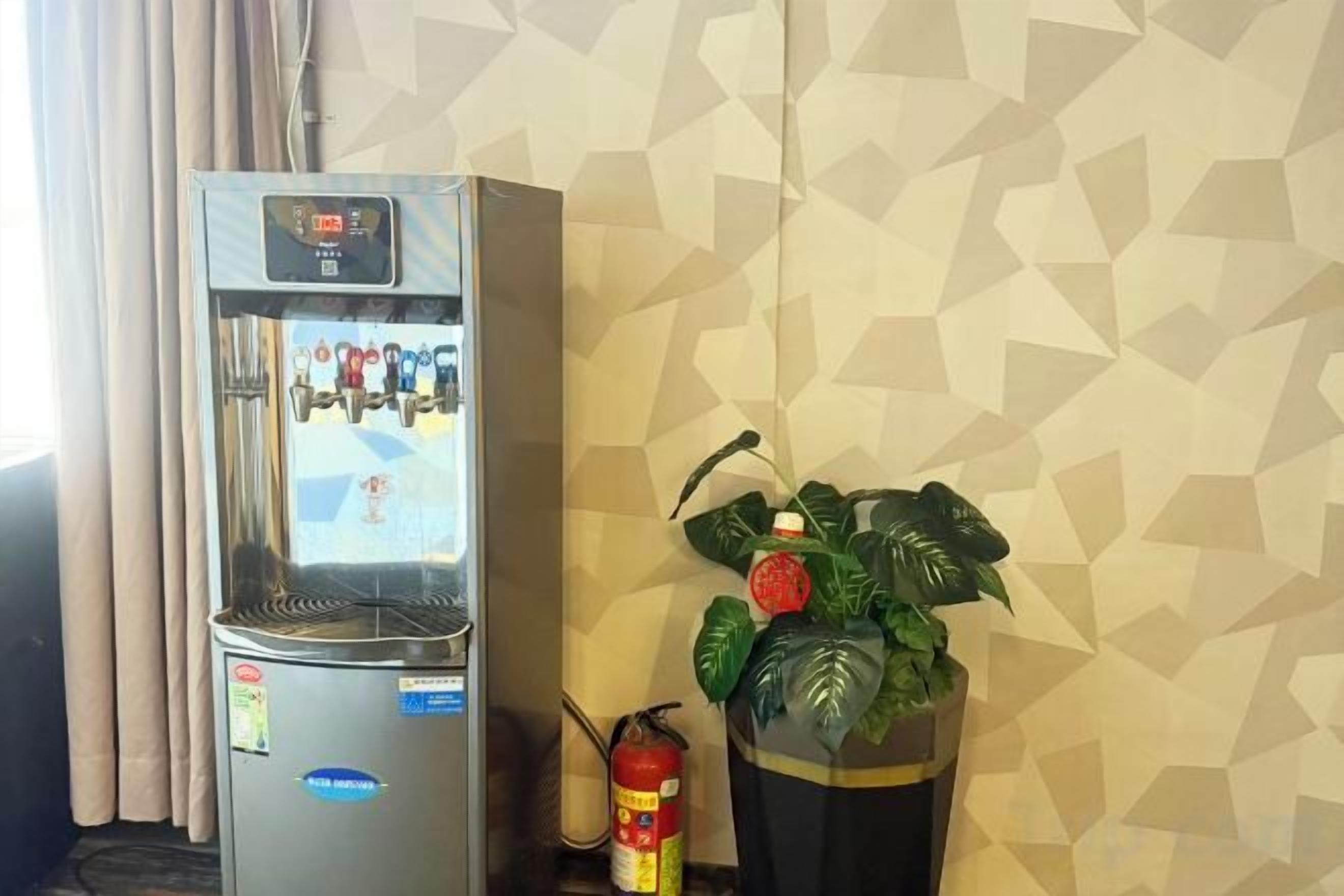 A minibar with a refrigerator and a potted plant.