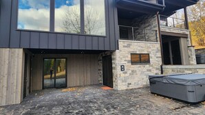 A modern two-story building with large windows and a stone facade. - Ski Out on Whitefish Mountain 3BD 4BA Sleeps 14+ Unbeatable SKI Location (Whitefish)