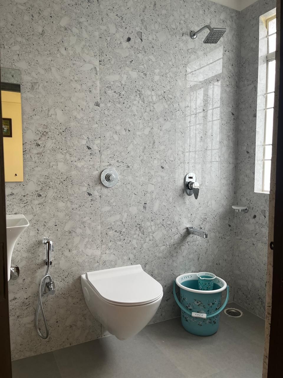 A bathroom with a white toilet, a shower, and a sink.
