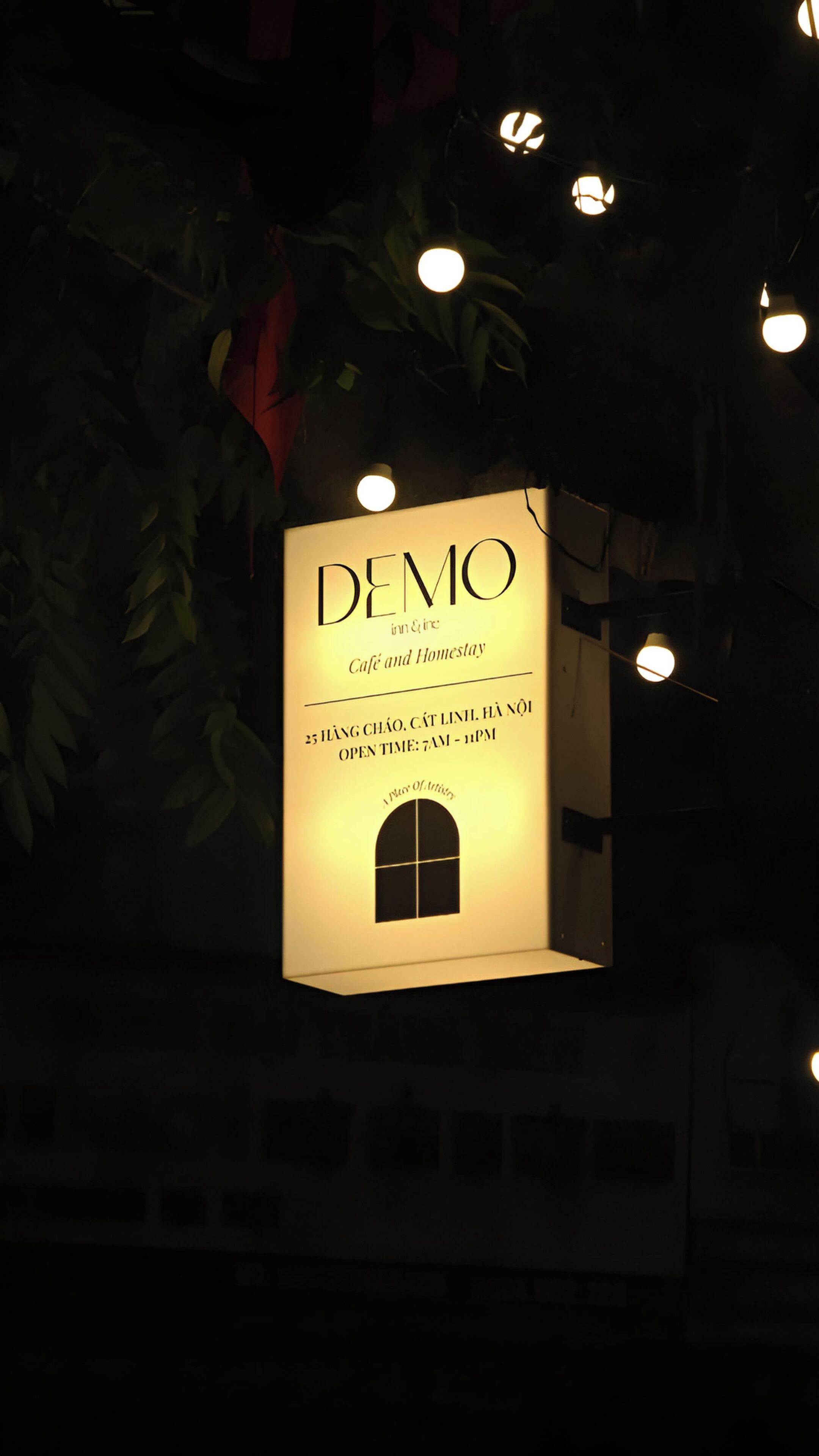 A hanging sign for a café and homestay named "DEMO" with operating hours listed.