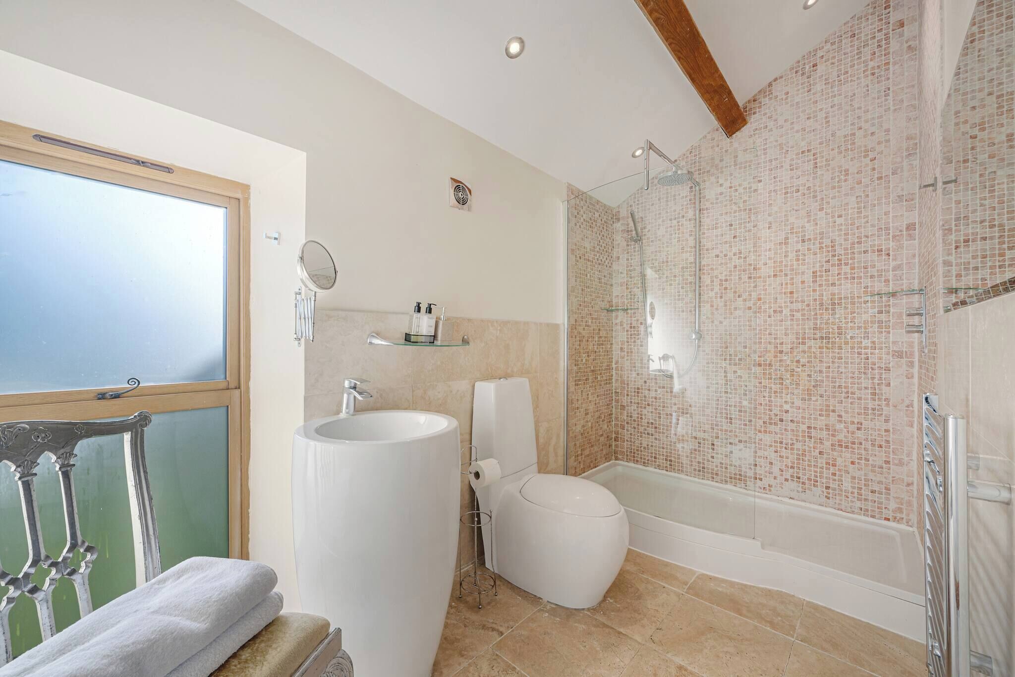 A bathroom with a large sink, toilet, and bathtub.