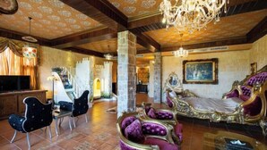 A room with a large bed, a chandelier, and a television. - Xin Yuan-My Dream Castle (Yilan)