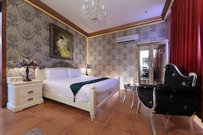 A bedroom with a bed, bedside tables, a chandelier, a mirror, and a chair. - Xinyuan My Dream Castle (Yilan)