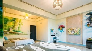 A hotel room with a bed, a desk, a chair, a door, and a wall with a mural. - Melinda Resort (Pingtung)