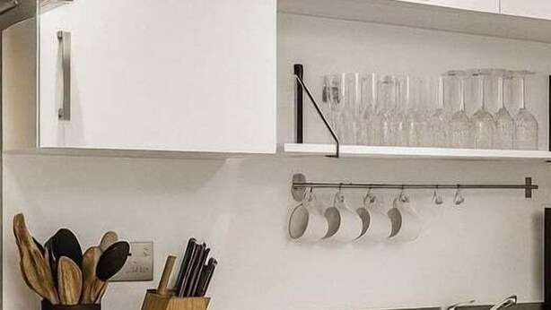 A modern kitchen with white cabinets, a stainless steel sink, and a wooden countertop. - Reading Retreat 1 Bed With Private Parking (Reading)