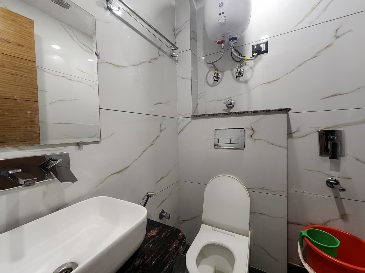 A bathroom with a white sink, toilet, and shower.