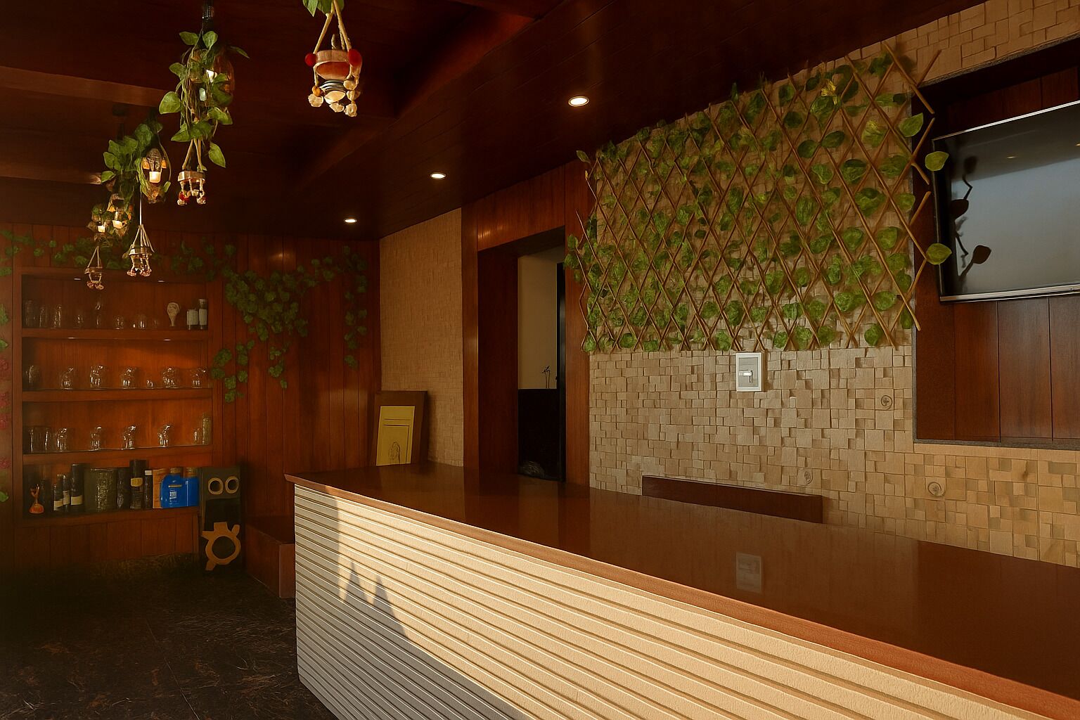 A reception area with a wooden counter, shelves with glassware, and a wall with a green leafy pattern.