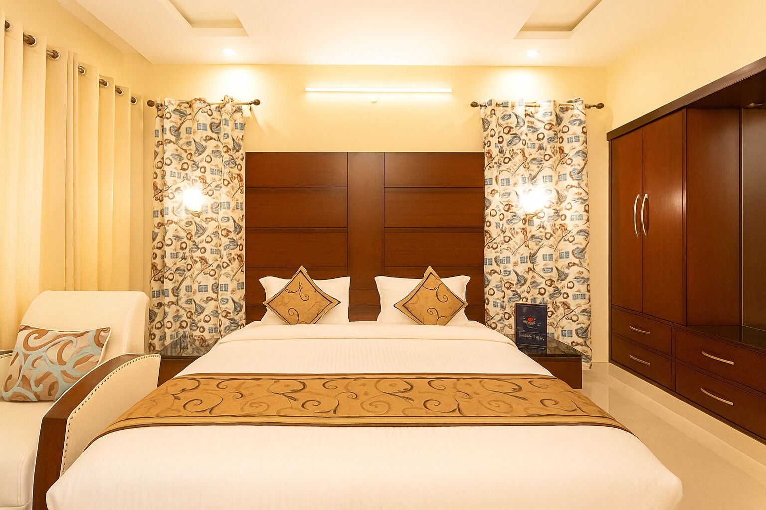 A hotel room with a large bed, two curtains, a nightstand, a wardrobe, and a chair.