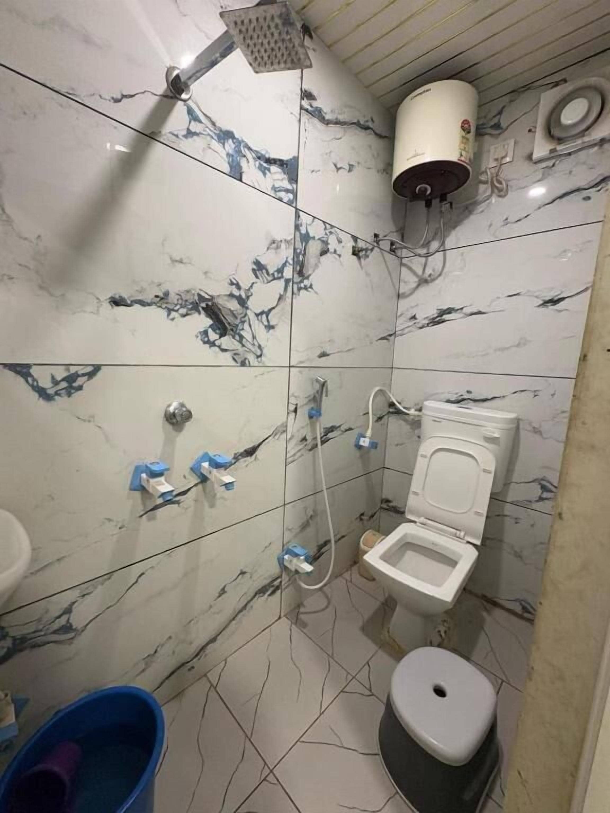 A small bathroom with a toilet, bidet, and shower.