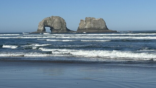 A beach with two large rock formations in the distance. - Lakeview Home steps away Twin Rocks Beach Access (Rockaway Beach)