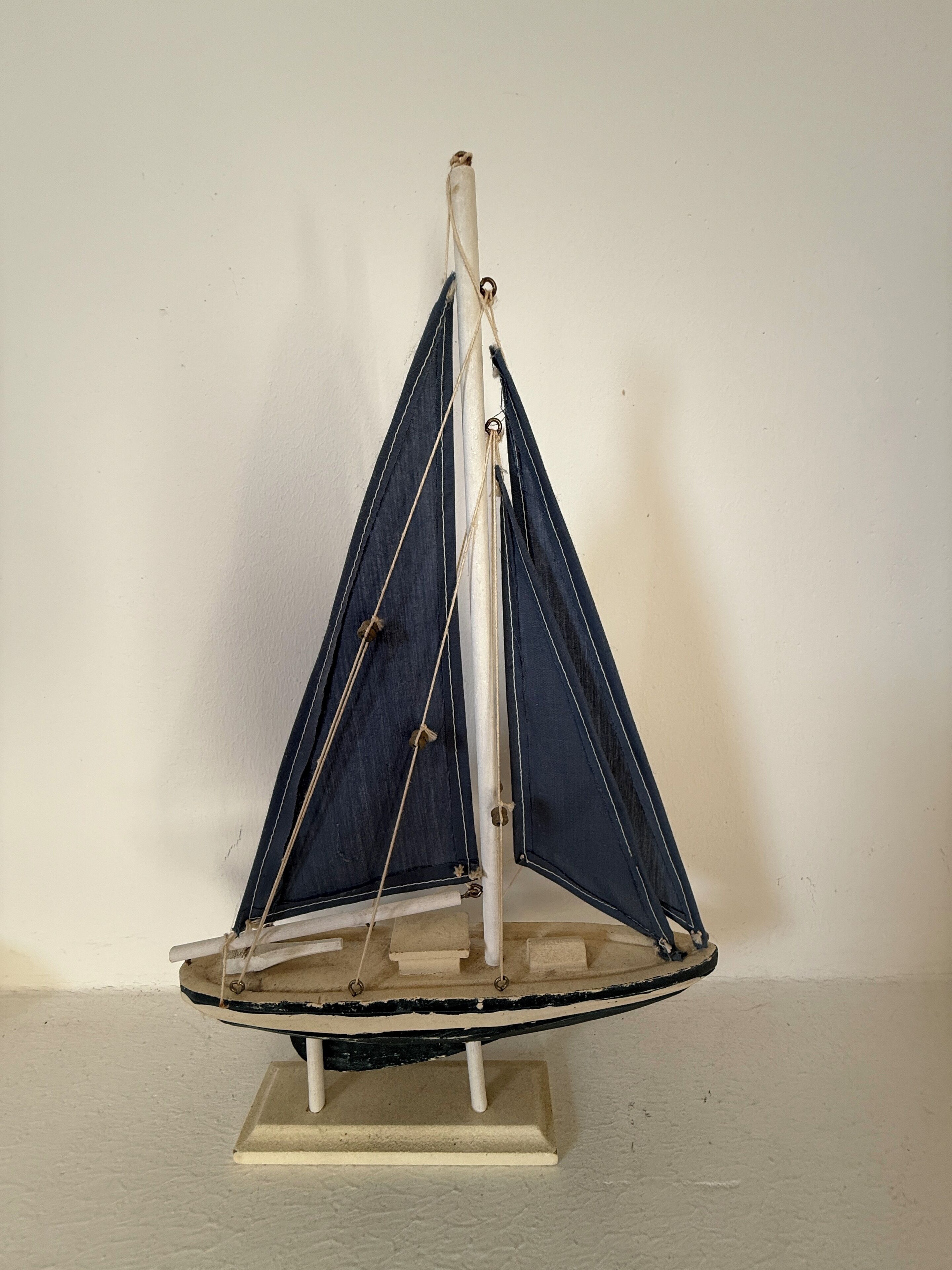 A model sailboat on a stand.