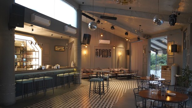 A modern bar area with a patterned floor, bar stools, and a counter. - KMR Hotels & Resorts (Bikaner)