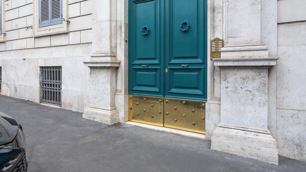 A building with a large, ornate green door, white columns, and a number '36' sign. - Relais Pinciana (Rome)