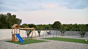 A playground with a wooden swing set, a slide, and a soccer goal. - Villa Donatus Zadarvillas (Policnik)