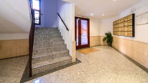 A staircase with a wooden handrail leading to a door with a glass panel. - Stylish accommodation: 2 bedrooms, air conditioning and all mod cons HOR1K1B (Madrid)