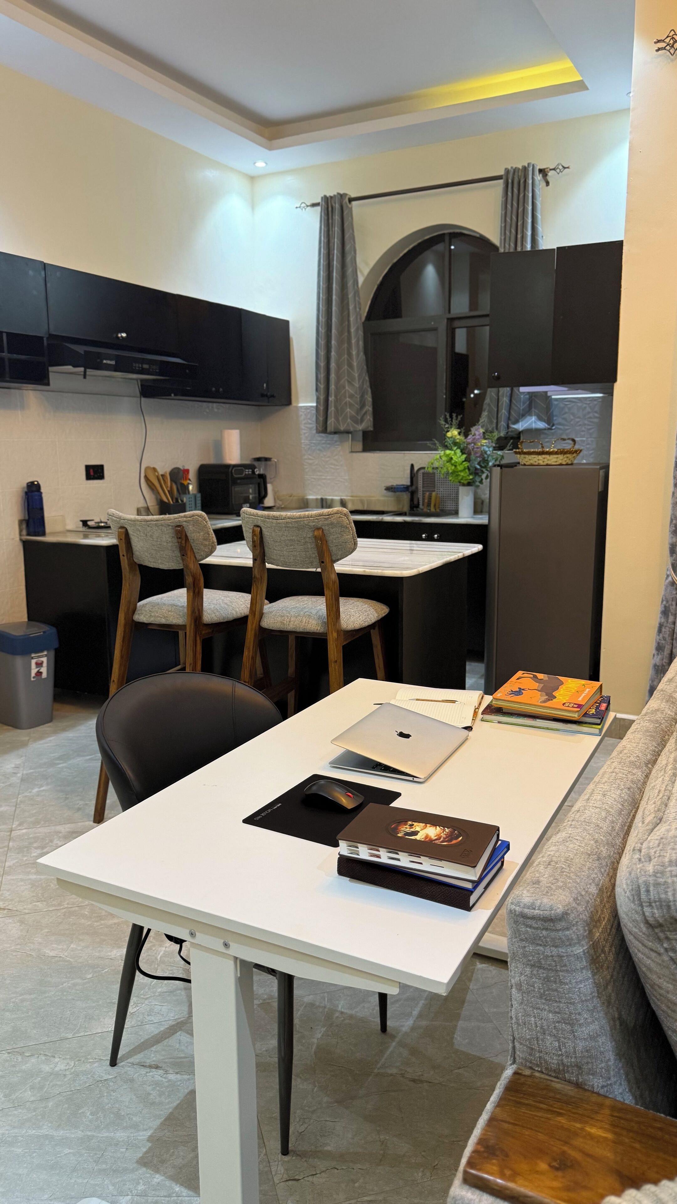 A compact living space with a dining area, a kitchenette, and a seating area with a sofa.