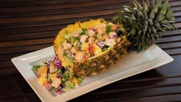 A pineapple bowl salad on a white plate.
