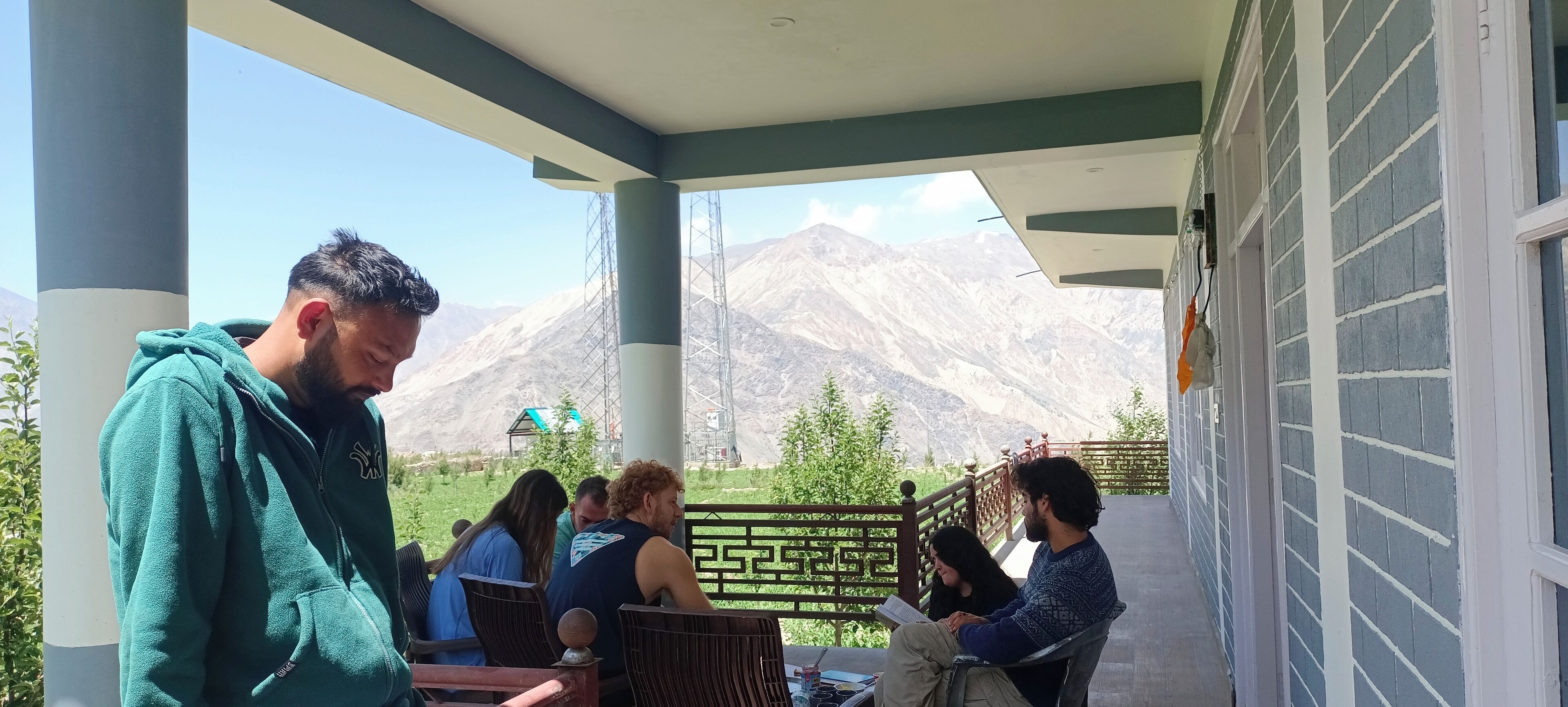 A covered outdoor seating area with a view of mountains.