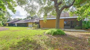 A residential area with a house featuring a large tree in the front yard. - 5 Mi to Anna Maria Island: Apt w/ Pool Access! (Bradenton)