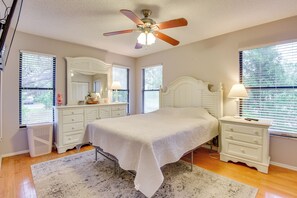 A bedroom with a bed, a nightstand, a dresser, a ceiling fan, and a window with blinds. - 5 Mi to Anna Maria Island: Apt w/ Pool Access! (Bradenton)