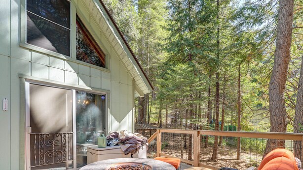 A deck with a fire pit, outdoor seating, and a view of the forest. - 4 Mi to State Park: Quiet Escape w/ Deck in Arnold (Arnold)