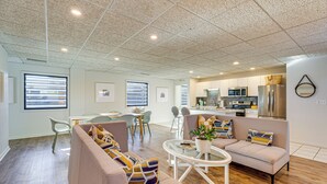 A modern living room with a sofa set, a coffee table, and a dining area with chairs. - Between Restaurant & Brewery! Chic Perrysburg Apt (Perrysburg)