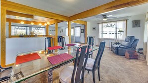 A dining area with a glass table, wooden beams, and a ceiling fan. - Mtn-view Colorado Haven! 32 Mi to Royal Gorge Park (Cotopaxi)